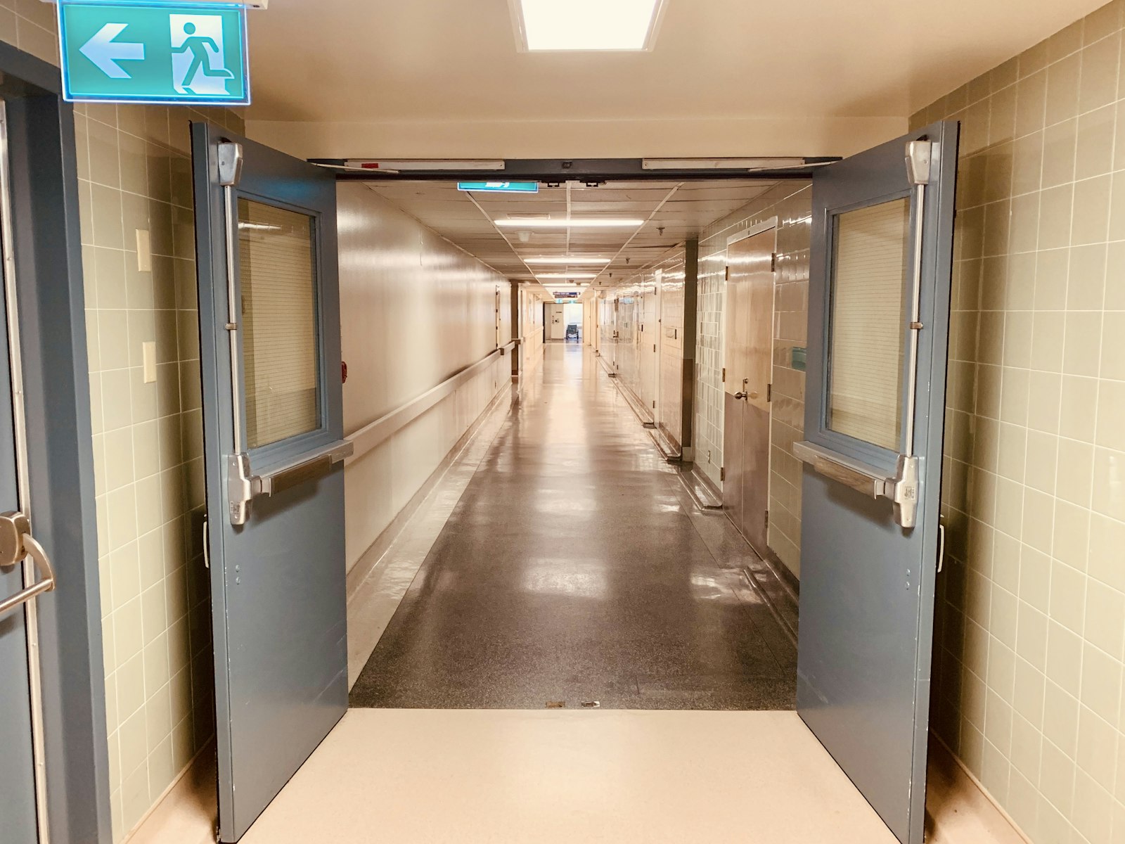 A warmly lit healthcare ward corridor