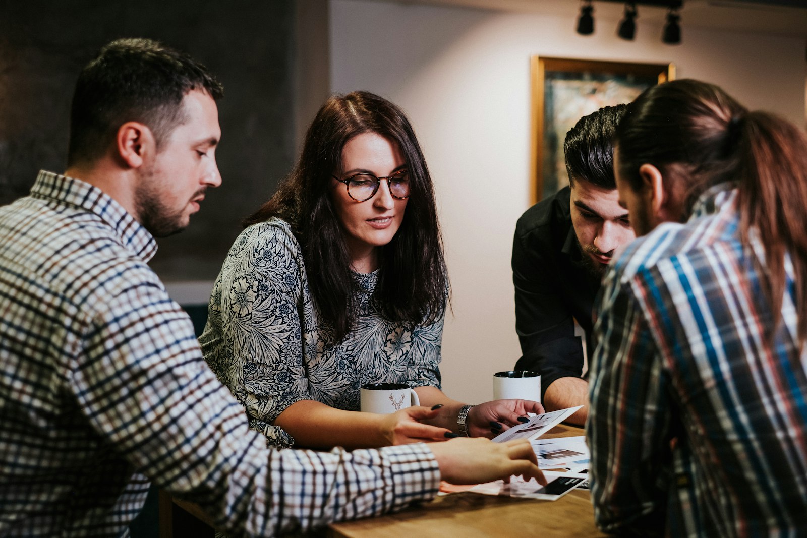 A finance team reviewing work together at a desk