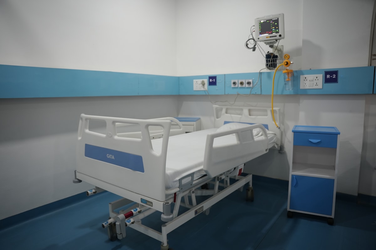 Tidy modern hospital ward with a freshly made empty bed
