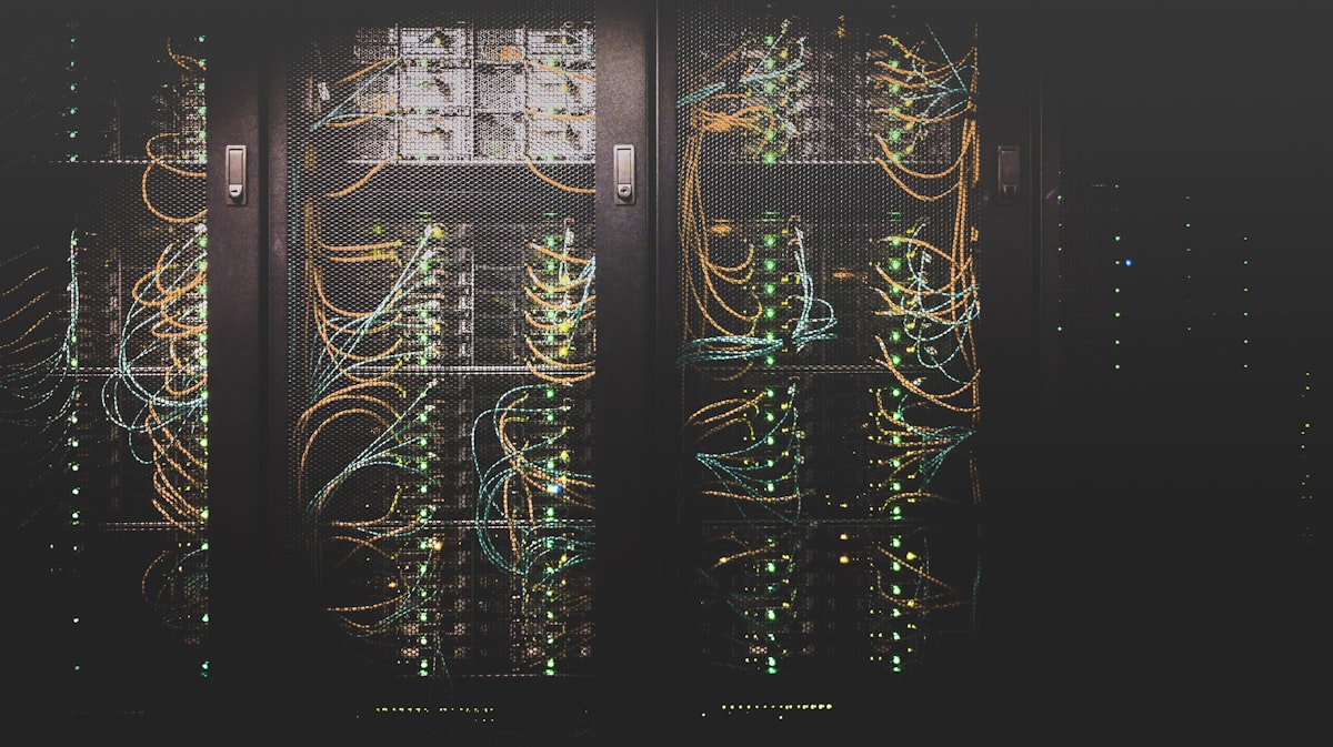 Rows of server racks with neatly cabled IT hardware in an equipment room